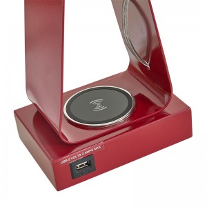 Lille skrivebordslampe med rød finish, en USB -opladningsport, en trådløs opladningsstation og en på/off rockerkontakt på værelsesrummet